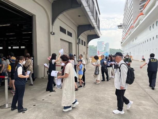 旅客下船後抵達基隆港旅運大樓入口處，由移民官進行人證核對。