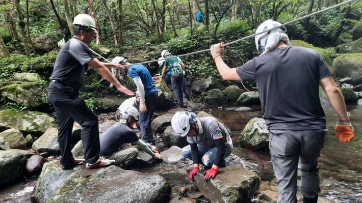 內柑宅古道中段需跨越八連溪，步道志工與社區居民正在整理跨溪點，讓遊客可以安心渡河