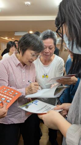 內政部部長劉世芳為小橘書簽名