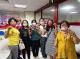 New immigrant families take a group photo with a sachet in hand.JPG