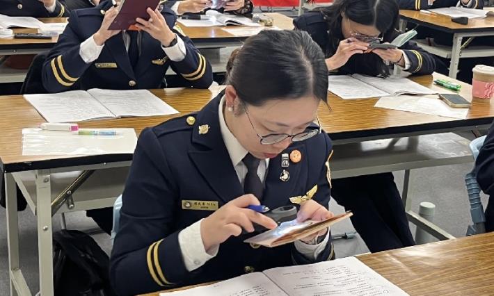 The National Immigration Agency hosts the 15th Document Examination Expert Competition, with immigration officers carefully examining passports to determine their authenticity