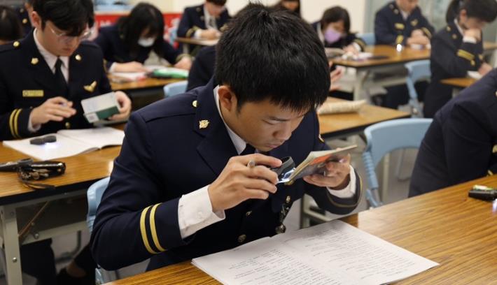 The National Immigration Agency hosts the 15th Document Examination Expert Competition, with immigration officers carefully examining passports to determine their authenticity